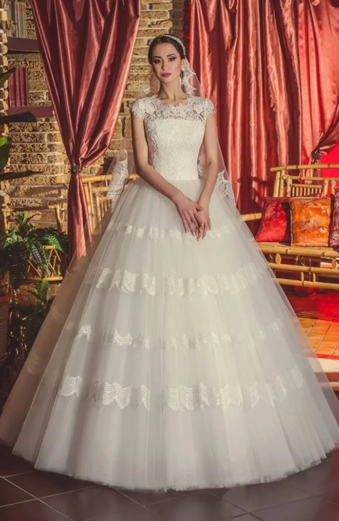 ---Ivory princess wedding dress with a tight lace bodice, short sleeves and a full tulle skirt with lace appliqués--