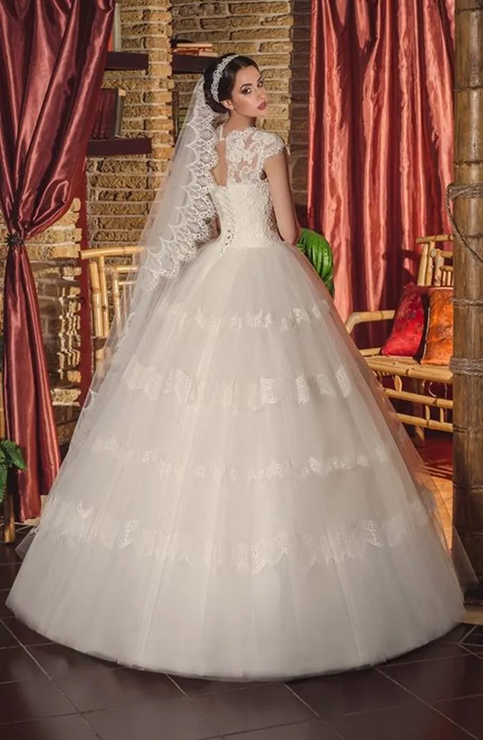 ---Ivory princess wedding dress with a tight lace bodice, short sleeves and a full tulle skirt with lace appliqués--
