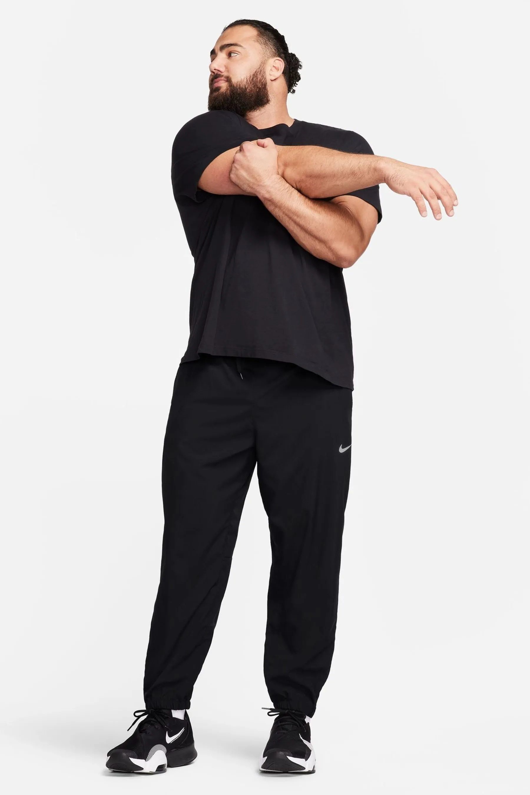 Nike - Pantaloni da jogging da allenamento Dri-FIT stretti in fondo