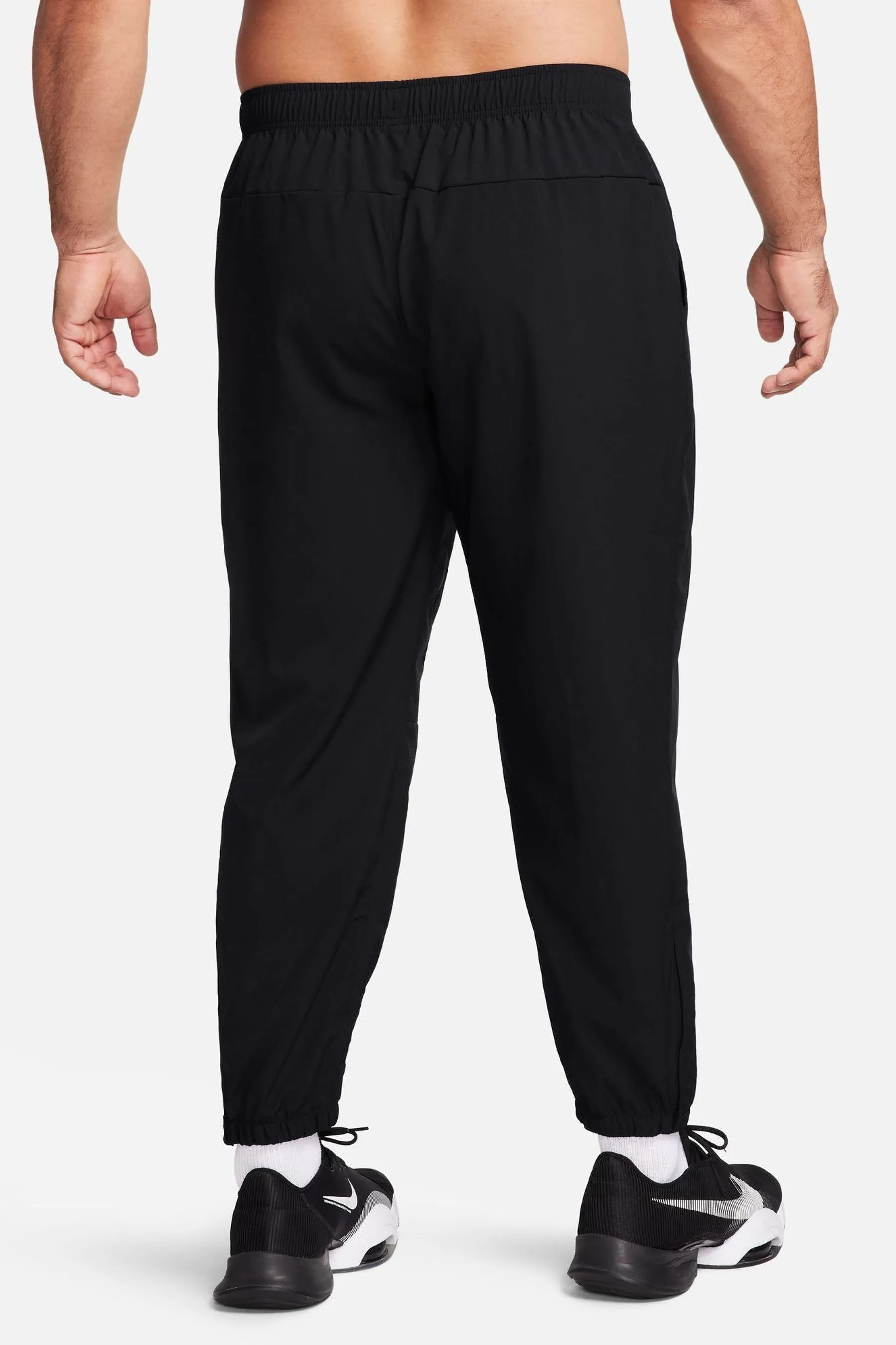 Nike - Pantaloni da jogging da allenamento Dri-FIT stretti in fondo